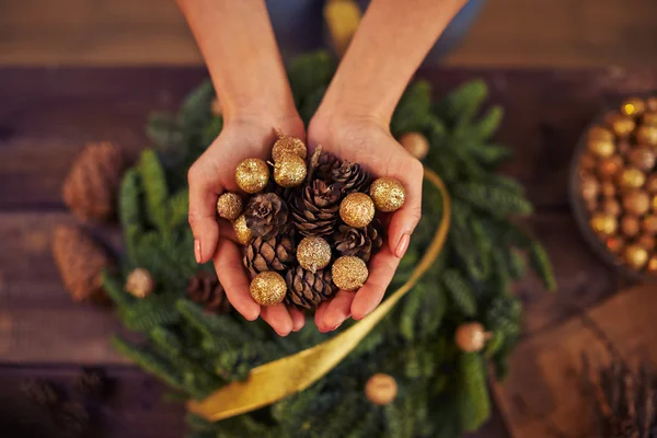 Mani con coni di abete e palle — Foto Stock