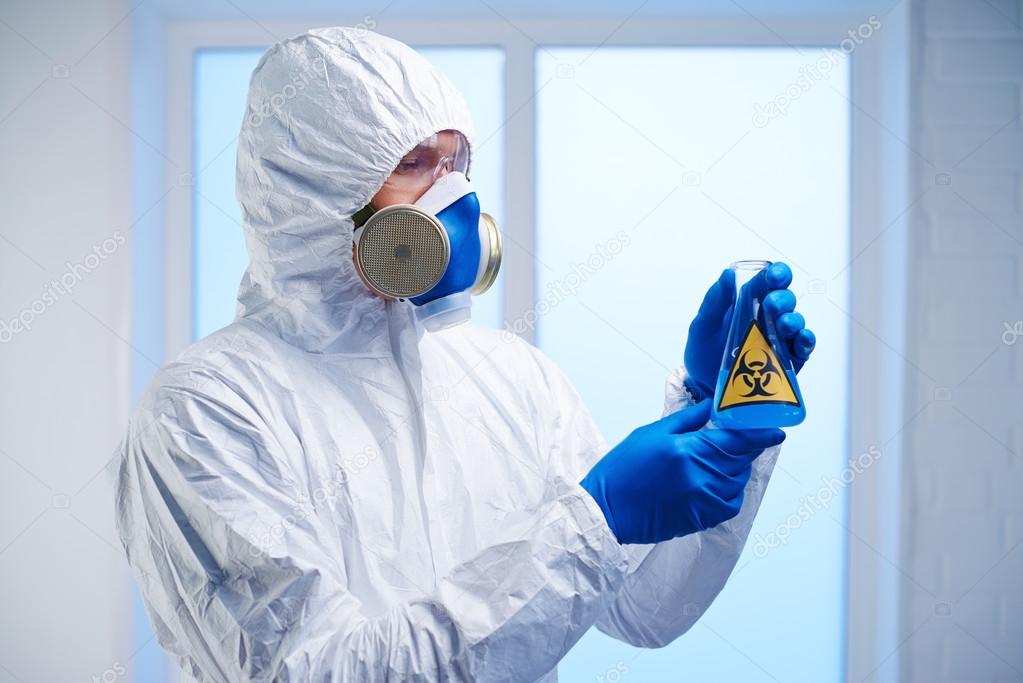 Scientist with biohazard fluid in lab