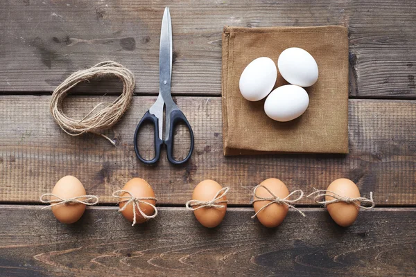 Eggs, linen napkin, scissors and threads — Stock Photo, Image