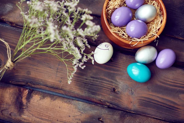 Easter eggs and dry flowers — Stock Photo, Image