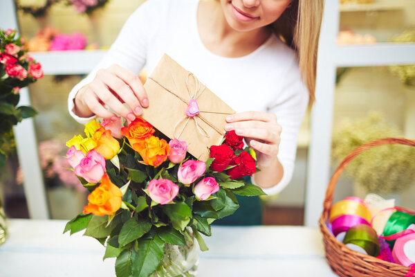 Woman  putting love message in bouquet