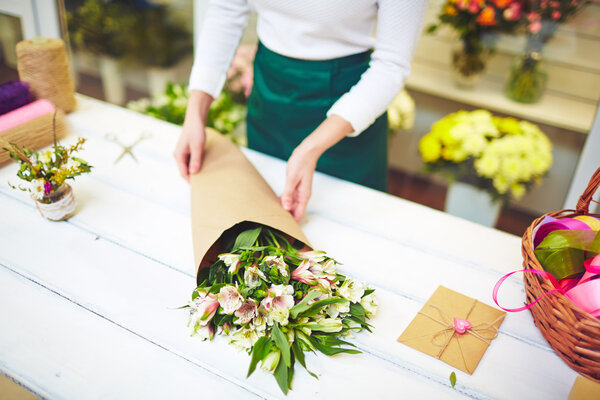 Florist selling bouquet of amaryllises