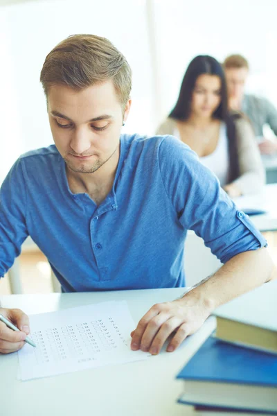 Student ticking right answers Stock Image