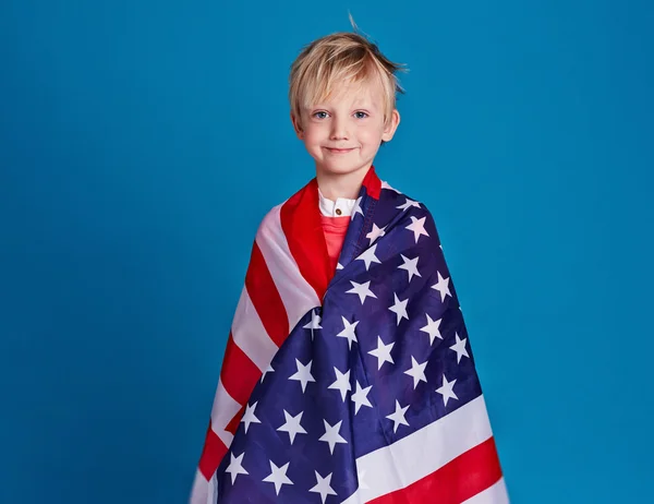 Boy wrapped in American flag — Stock Photo, Image