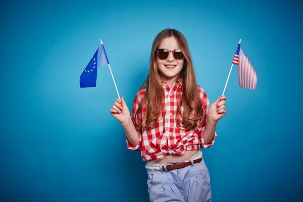Girl keeping flags — Stock Photo, Image