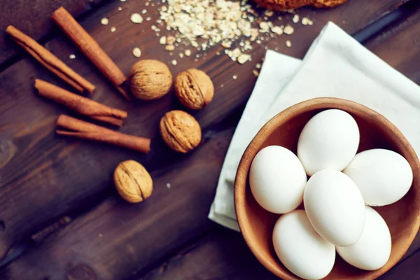 Eggs, walnuts, cinnamon sticks and cereal — Stock Photo, Image