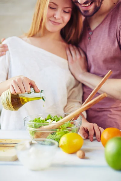 Woman seasoning salad — Stock Photo, Image