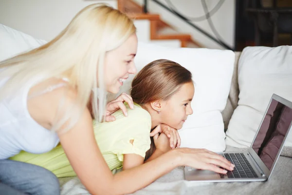 Mor och dotter tittar på en dator — Stockfoto