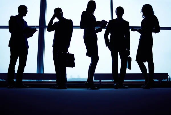 Business partners communicating against window — Stock Photo, Image