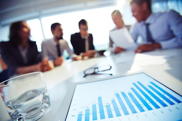 Paper with charts and glass of water — Stock Photo, Image