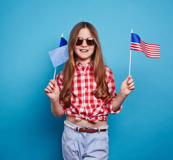 Little girl with USA and EU flags — Stock Photo, Image