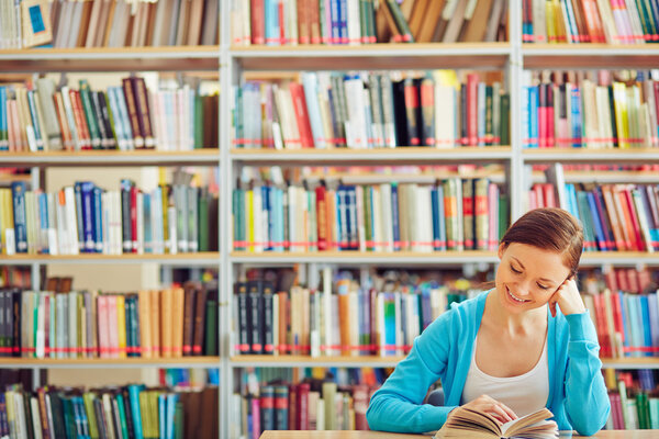 student reading book in library