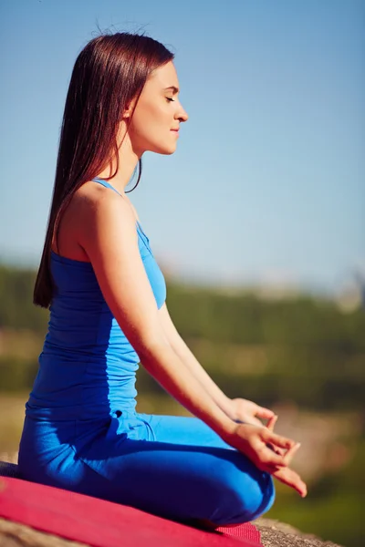 Woman relaxing in pose of lotus — Stock Photo, Image