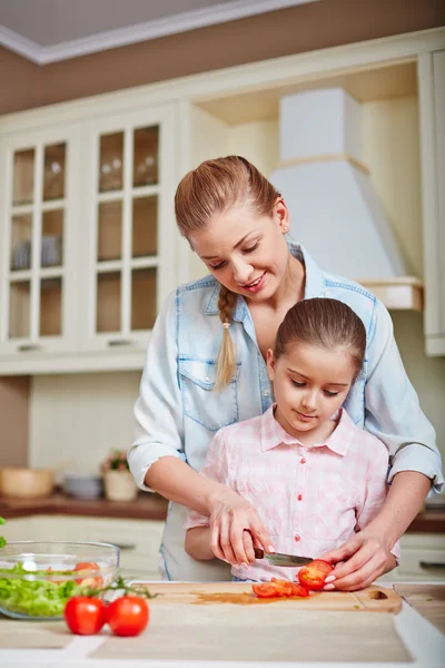 Woman and daughter cutting tomatoes — Stock Photo, Image