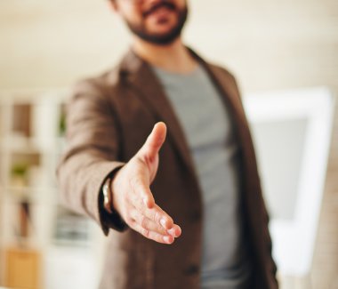 Businessman giving his hand for handshake clipart