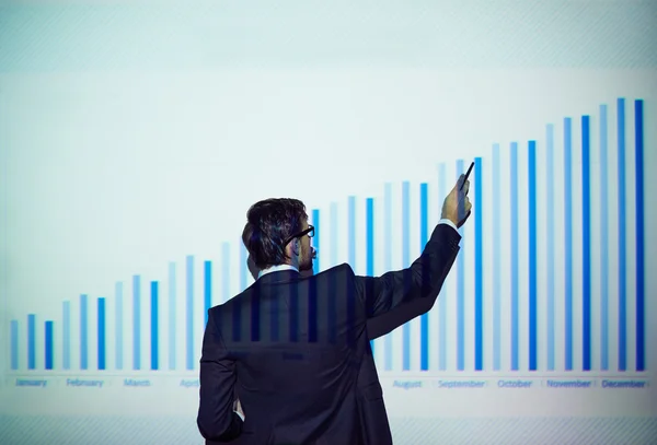Businessman with touchpad explaining chart — Stock Photo, Image