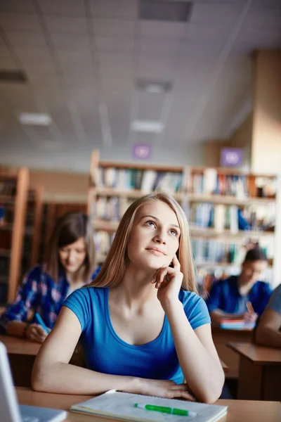 Cute girl daydreaming at lesson — Stock Photo, Image