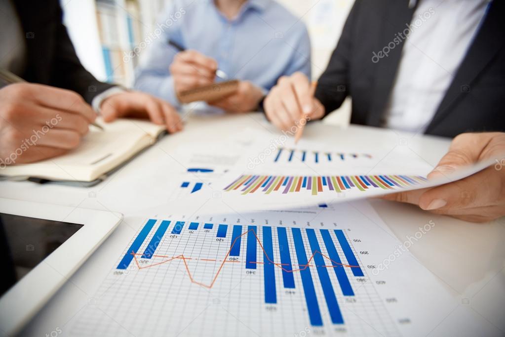 Businessman pointing at paper with chart