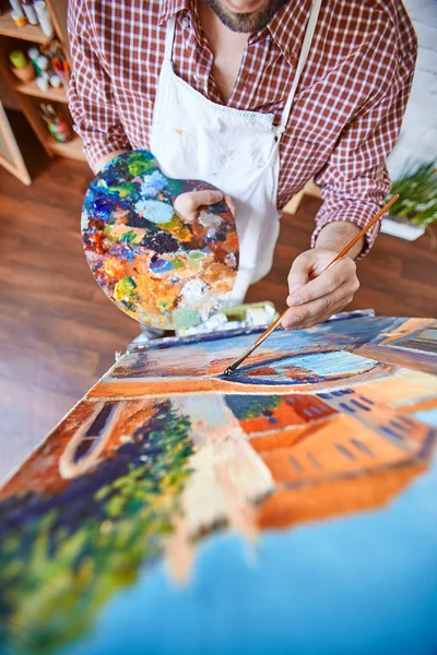 Artist painting with paints on canvas — Stock Photo, Image