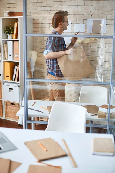 Young architect with blueprint — Stock Photo, Image