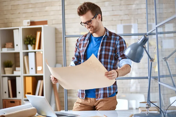 Architect with blueprint in office — Stock Photo, Image