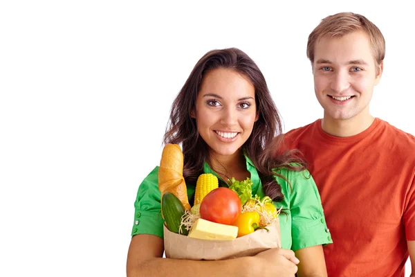 Girl holding sack with products and her boyfriend — Stock Photo, Image