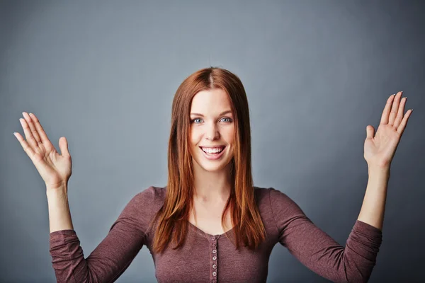 Young woman keeping her arms raised — Stock Photo, Image