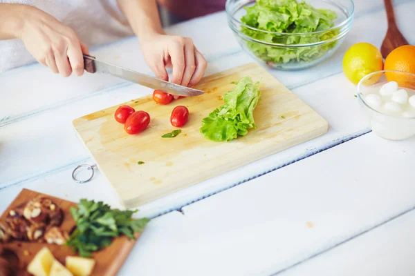 Hands of female cutting ingredients — Stock Photo, Image