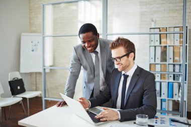 businessman showing his colleague information