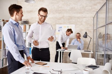 Young colleagues interacting at meeting