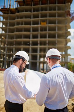 engineers discussing sketch of new building
