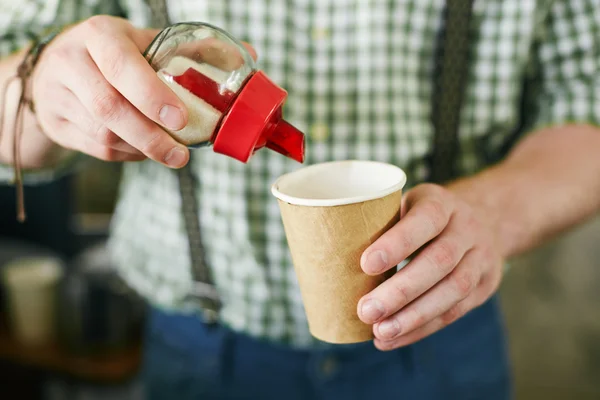 Putting sugar in coffee — Stock Photo, Image