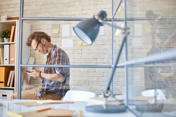 Zakenman schrijven sms in office — Stockfoto