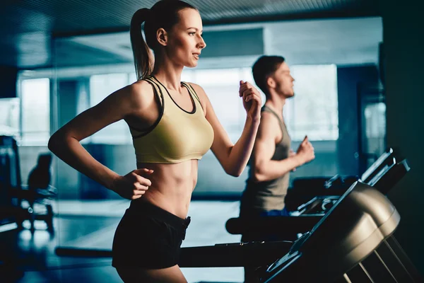 Woman running on treadmill — Stock Photo, Image