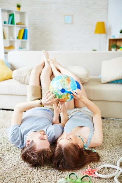 Couple choosing place on globe where to travel — Stock Photo, Image