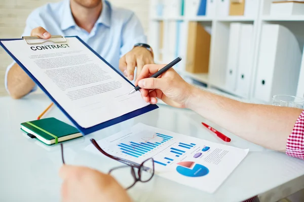 Businessman holding contract and partner signing it — Stock Photo, Image