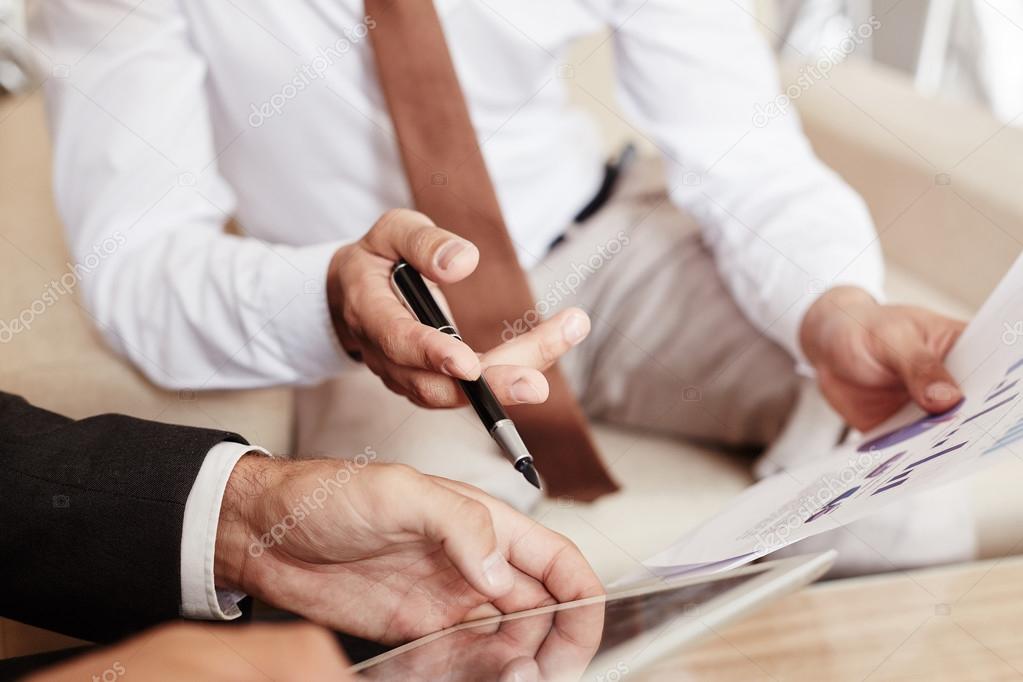 businessmen discussing documents