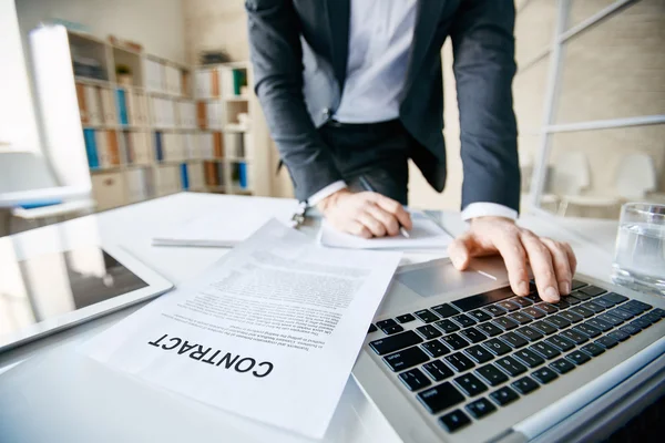 Businessman in formalwear pushing laptop buttons — Stock Photo, Image