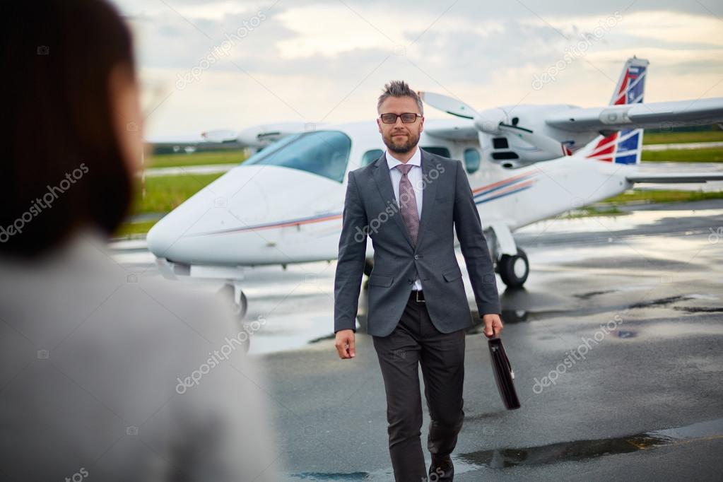 businessman with briefcase hurrying to meet his partner