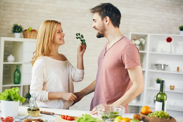 Femme donnant du persil à un jeune homme — Photo