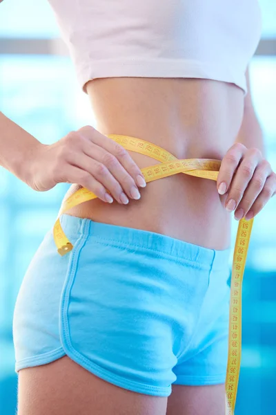 Slim woman measuring her waist — Stock Photo, Image