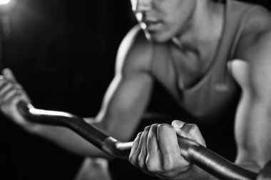 man lifting heavy metal weight