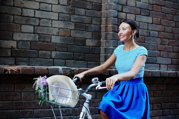Woman dressed in retro style riding bicycle — Stok fotoğraf