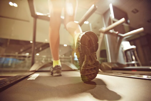 woman running on treadmill