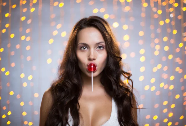 Woman with lollipop on her lips — Stok fotoğraf