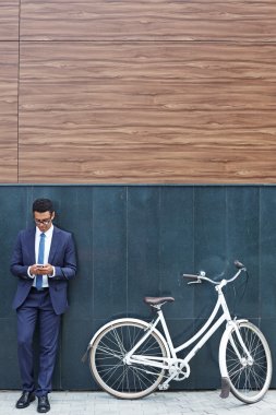 Handsome businessman reading sms