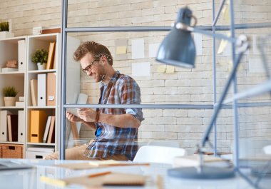 Handsome architect with touchpad