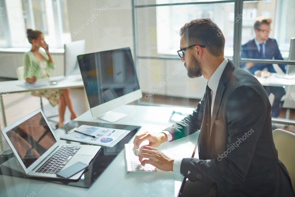 businessman looking at computer monitor