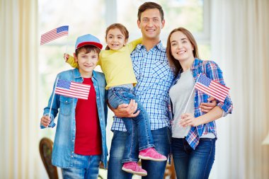 American family  holding flags clipart