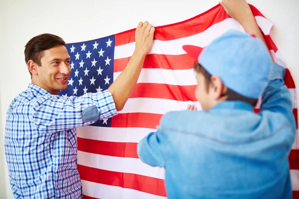 Man and son hanging USA flag — Stock Photo, Image